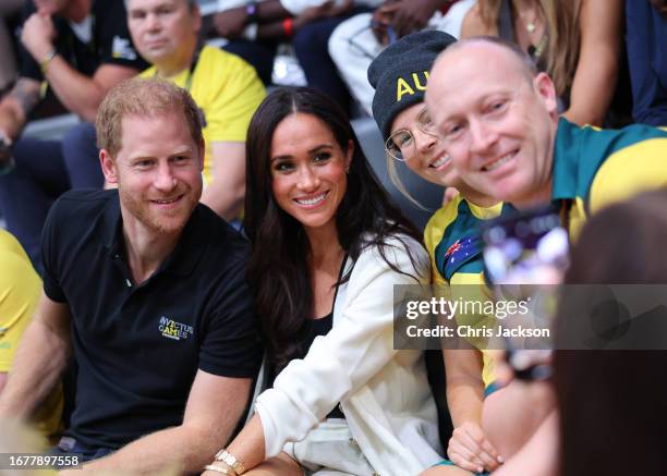 Prince Harry, Duke of Sussex and Meghan, Duchess of Sussex pose for a photograph as they attend the Wheelchair Basketball preliminary match between...