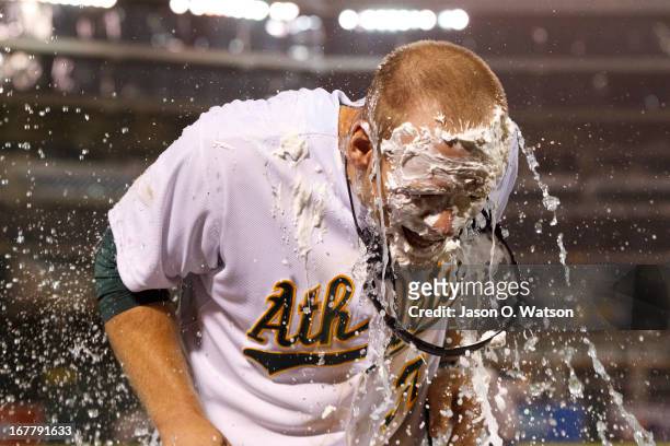Brandon Moss of the Oakland Athletics reacts after getting hit with a pie and Gatorade after hitting a walk off two run home run against the Los...
