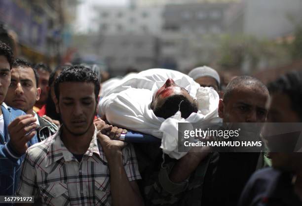 Palestinians mourners carry the body of Haitham Al-Meshal, during his funeral in Gaza City, on April 30, 2013. An Israeli air strike on Gaza City...