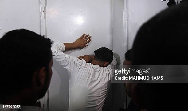 The Palestinian borther of Haitham Al-Meshal, grieves at the Shifa hospital before the funeral in Gaza City, on April 30, 2013. An Israeli air strike...
