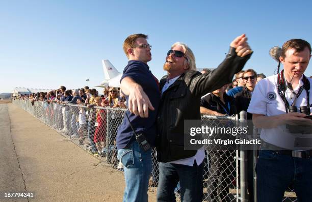 Sir Richard Branson "chest bumps" Scaled Composites engineer Jason DiVenere following a sucessful rocket motor burn on SpaceShipTwo's first powered...