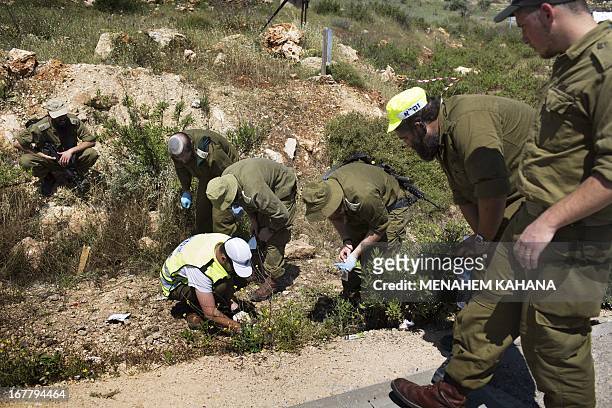 Israeli soldiers search for human remains at the site where an Israeli settler was stabbed to death by a Palestinian man in the Tapuah junction near...