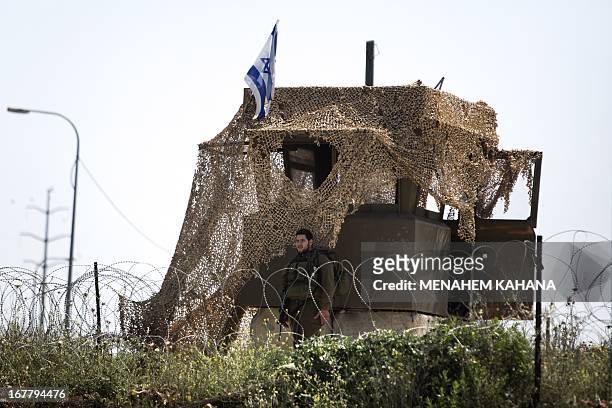 An Israeli soldier stand guards at an army post near the site where an Israeli settler was stabbed to death by a Palestinian man in the Tapuah...