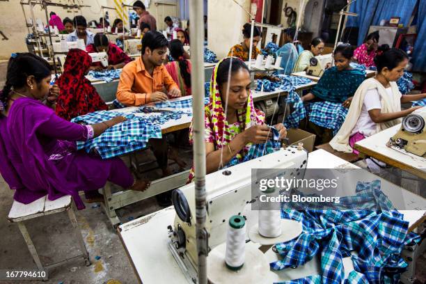 Workers prepare and sew plaid shirts on the production line of the Fashion Enterprise garment factory in Dhaka, Bangladesh, on Monday, April 29,...