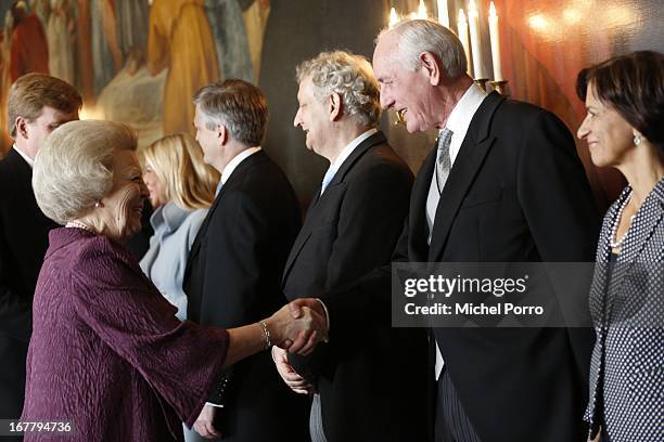 Queen Beatrix of the Netherlands greets Queen's Commissioner of North Holland Johan Remkes as she arrives for the Act of Abdication in the Moseszaal...