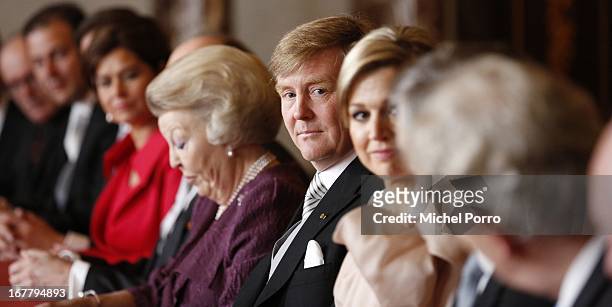 Prince Willem-Alexander of the Netherlands sits alongside his mother Queen Beatrix of the Netherlands during her abdication ceremony in the Moseszaal...