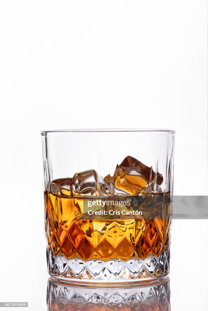 Whiskey on the rocks on white background