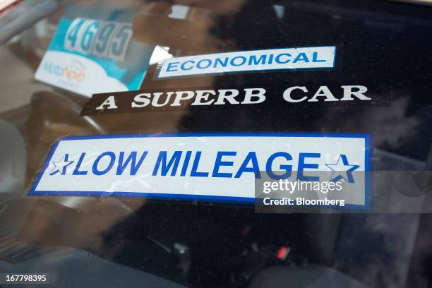 Stickers alert potential customers to the features of an automobile at an independent second-hand car dealership in Leigh-on-Sea, U.K., on Monday,...