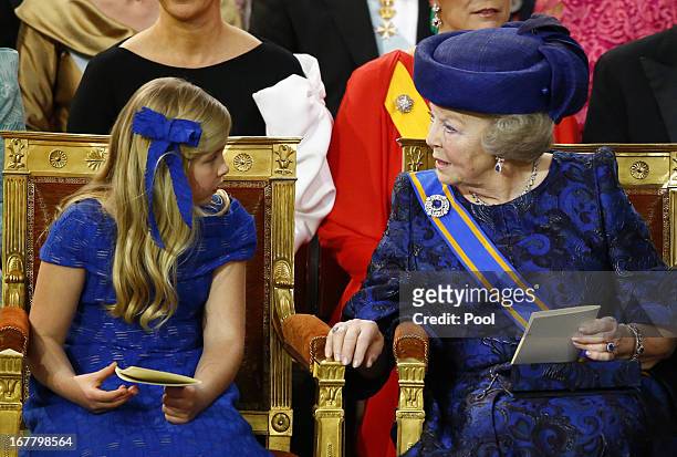 Princess Beatrix of the Netherlands sits with her granddaughter Princess Catharina-Amalia of the Netherlands during the inauguration of HM King...