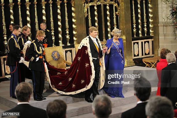 King Willem Alexander and Queen Maxima of the Netherlands prepare to leave after their inauguration ceremony at New Church on April 30, 2013 in...