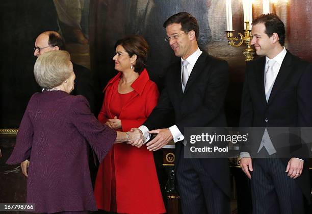 Queen Beatrix of the Netherlands greets Mark Rutte and Anouchka van Miltenburg during a ceremony in the Moseszaal at the Royal Palace on April 30,...