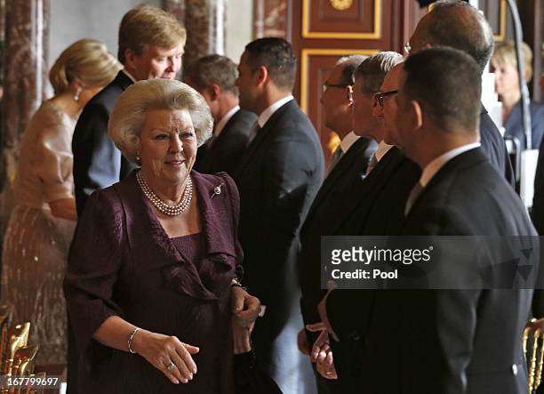 Queen Beatrix of the Netherlands greets people during her abdication ceremony in the Moseszaal at the Royal Palace on April 30, 2013 in Amsterdam....