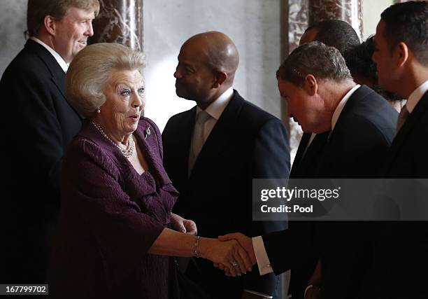 Queen Beatrix of the Netherlands greets people during her abdication ceremony in the Moseszaal at the Royal Palace on April 30, 2013 in Amsterdam....