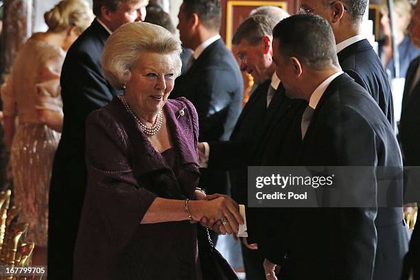 Queen Beatrix of the Netherlands greets people during her abdication ceremony in the Moseszaal at the Royal Palace on April 30, 2013 in Amsterdam....