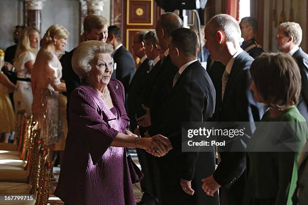 Queen Beatrix of the Netherlands greets people during her abdication ceremony in the Moseszaal at the Royal Palace on April 30, 2013 in Amsterdam....