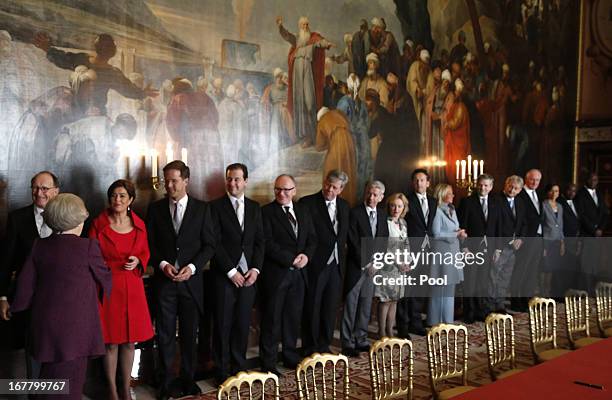 Queen Beatrix of the Netherlands greets people during her abdication ceremony in the Moseszaal at the Royal Palace on April 30, 2013 in Amsterdam....