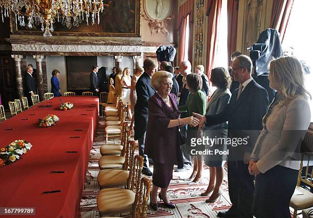 Queen Beatrix of the Netherlands greets people during her abdication ceremony in the Moseszaal at the Royal Palace on April 30, 2013 in Amsterdam....