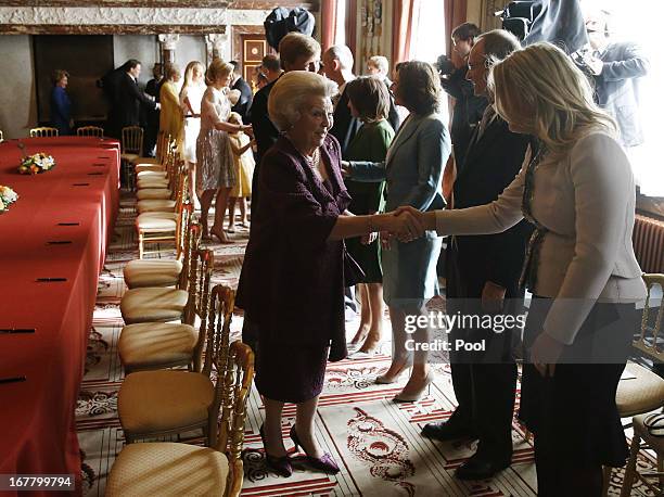 Queen Beatrix of the Netherlands greets people during her abdication ceremony in the Moseszaal at the Royal Palace on April 30, 2013 in Amsterdam....