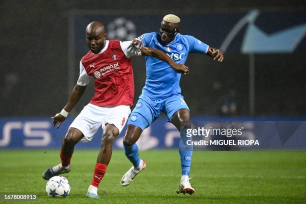 Napoli's Nigerian forward Victor Osimhen fights for the ball with Sporting Braga's Libyan midfielder Al-Motasim Al-Musrati during the UEFA Champions...