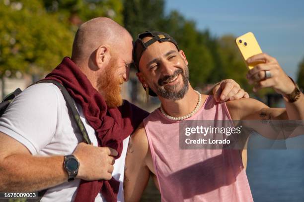 handsome casual gay male 50s tourist couple in amsterdam - civil partnership stock pictures, royalty-free photos & images