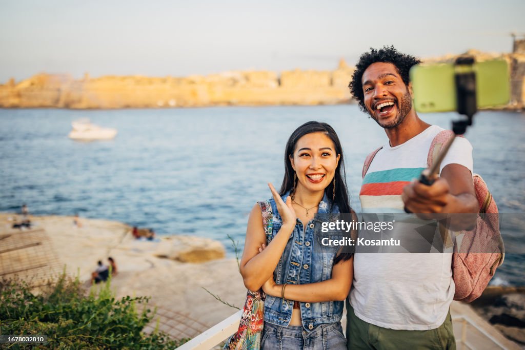 A day to remember. Two cheerful people are having crazy fun filming a travel vlog