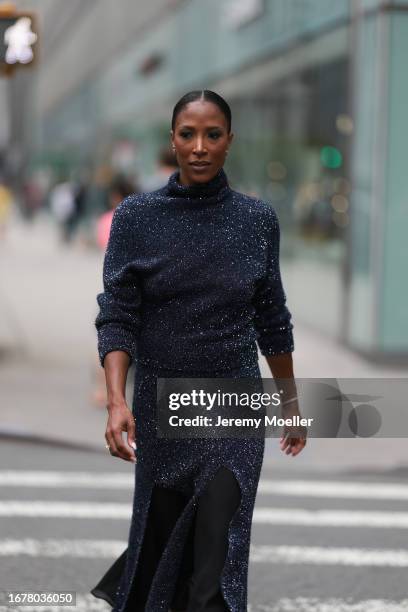 Guest is seen outside Proenza Schouler show wearing little diamond earrings, black colored crystalized dress with high neck and long sleeves and...