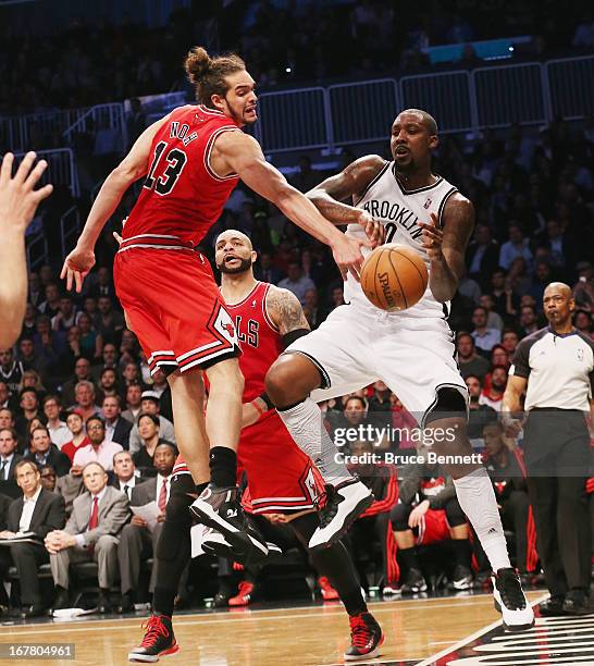 Andray Blatche of the Brooklyn Nets battles for a rebound with Joakim Noah of the Chicago Bulls during Game Five of the Eastern Conference...