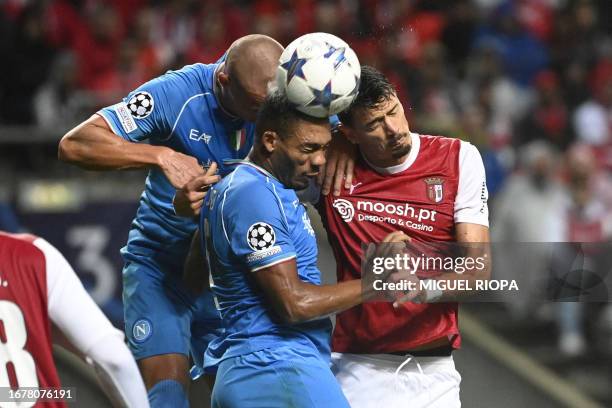 Napoli's Brazilian defender Juan Jesus and Napoli's Norwegian defender Leo Skiri Ostigard fights for the ball with Sporting Braga's Portuguese...