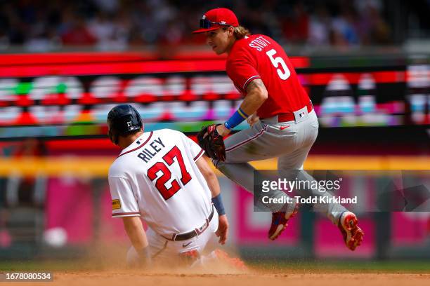 Austin Riley of the Atlanta Braves is out at second by Bryson Stott of the Philadelphia Phillies during the eighth inning at Truist Park on September...