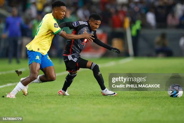 Sundowns' South African midfielder Themba Zwane fights for the ball with Pirate's South African midfielder Monnapule Saleng during the Premier Soccer...