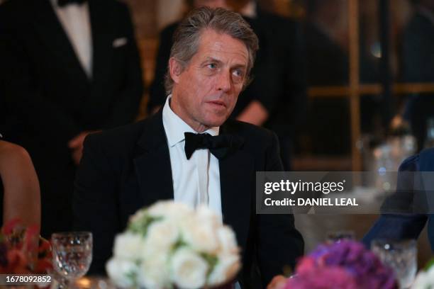 British actor Hugh Grant looks on during a state banquet at the Palace of Versailles, west of Paris, on September 20 on the first day of a British...