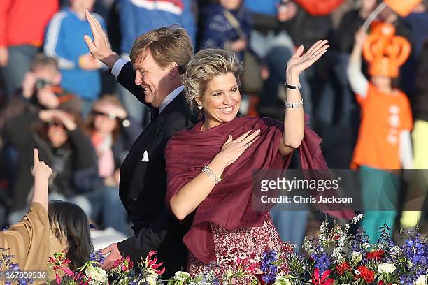 King Willem Alexander and Queen Maxima are seen aboard the Kings boat for the water pageant to celebrate the inauguration of King Willem of the...