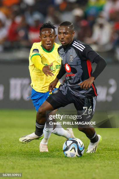 Pirate's South African midfielder Bandile Shandu vies for the ball with Sundowns' South African midfielder Thapelo Maseko during the Premier Soccer...