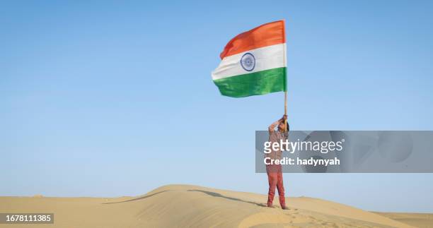 young indian boy waving indian national flag, india - indian national flag stock pictures, royalty-free photos & images
