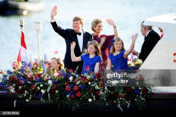 New Dutch King Willem-Alexander and Queen Maxima with Crown Princess Amalia , Princess Alexia and Princess Ariane wave to spectators and performers...