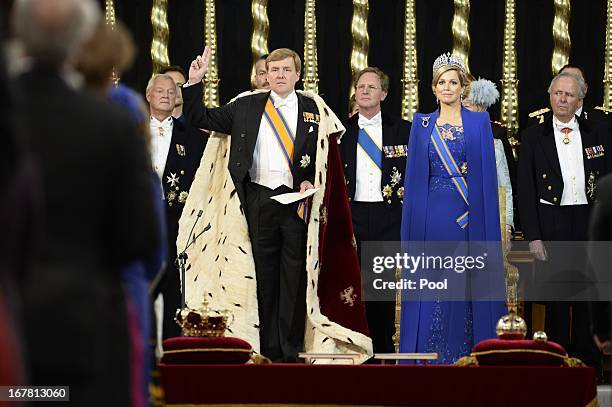 King Willem-Alexander of the Netherlands takes an oath as he stands alongside HM Queen Maxima of the Netherlands during his swearing in and...