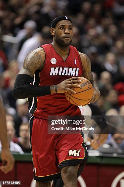 LeBron James of the Miami Heat dribbles up the court against the Milwaukee Bucks during Game Three of the Western Conference Quarterfinals of the...