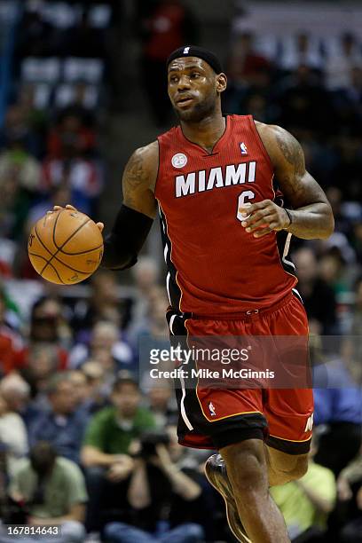LeBron James of the Miami Heat dribbles up the court against the Milwaukee Bucks during Game Three of the Western Conference Quarterfinals of the...