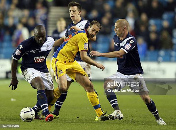 Danny Shittu of Millwall is tackled by Glenn Murray of Crystal Palace during the npower Championship match between Millwall and Crystal Palace at The...