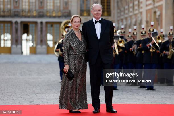 Yves de Gaulle , grand-son of Charles de Gaulle, and his partner Laurence arrive to attend a state banquet at the Palace of Versailles, west of...