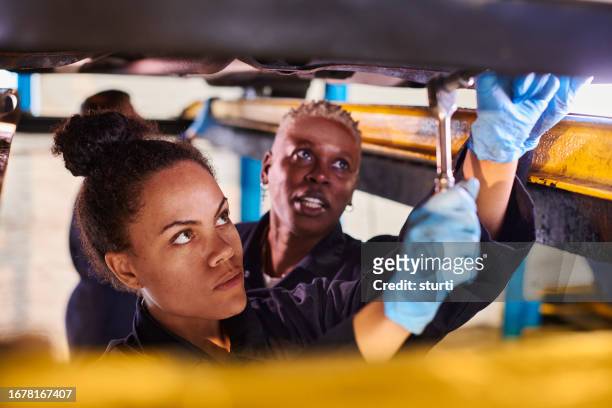 female apprentice mechanic with mentor - hand tool stock pictures, royalty-free photos & images