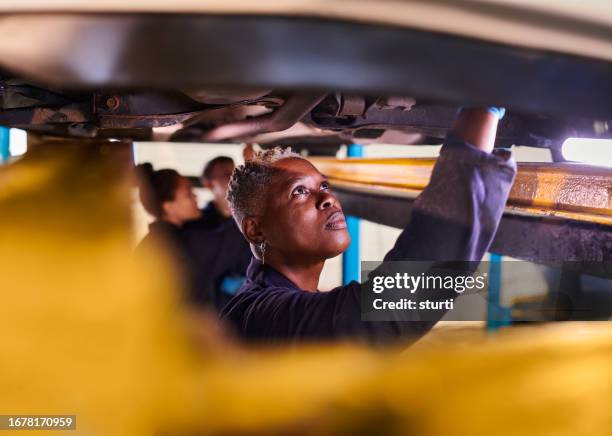 female car mechanic doing vehicle checks - hand tool stock pictures, royalty-free photos & images