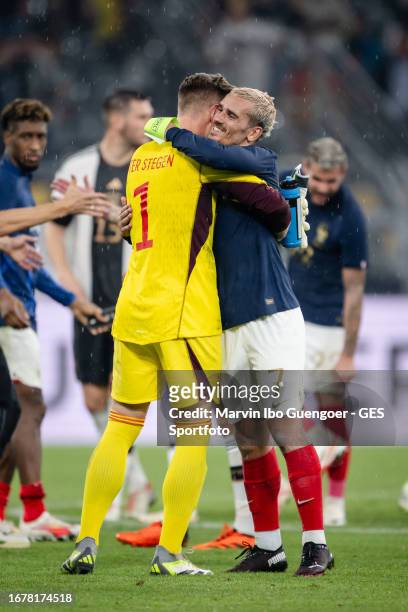 Marc-Andre ter Stegen of Germany shake hands with Antoine Griezmann of France after the international friendly match between Germany and France at...