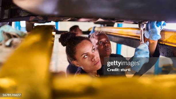 female apprentice mechanic with mentor - hand tool stock pictures, royalty-free photos & images