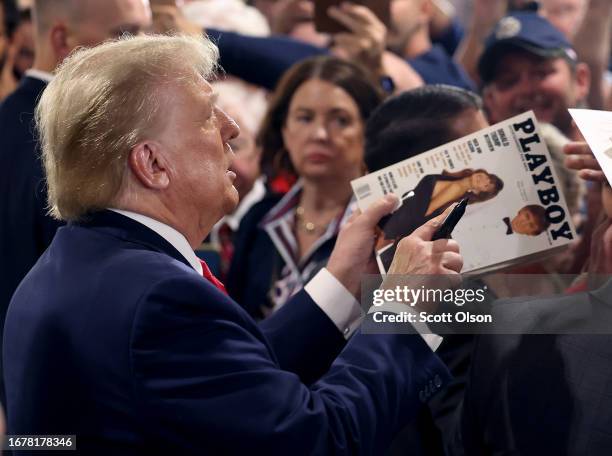 Republican presidential candidate and former U.S. President Donald Trump holds a copy of the March 1990 Playboy magazine where he appears on the...