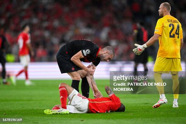 Salzburg's Serbian defender Strahinja Pavlovic helps Benfica's Argentinian forward Angel Di Maria during the UEFA Champions League 1st round day 1...