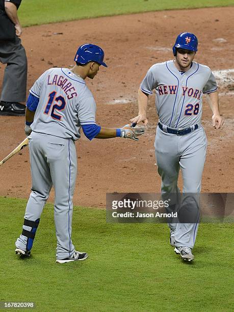 Marlon Byrd of the New York Mets celebrates scoring a run against the Miami Marlins with teammate Collin Cowgill at Marlins Park on April 30, 2013 in...