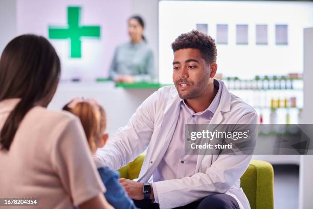 pharmacist consultation with mother and daughter - pharmacist stock pictures, royalty-free photos & images