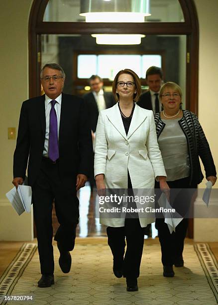 Treasurer Wayne Swan, Australian Prime Minister Julia Gillard and Disability Reform Minister Jenny Macklin arrive for a press conference at the...