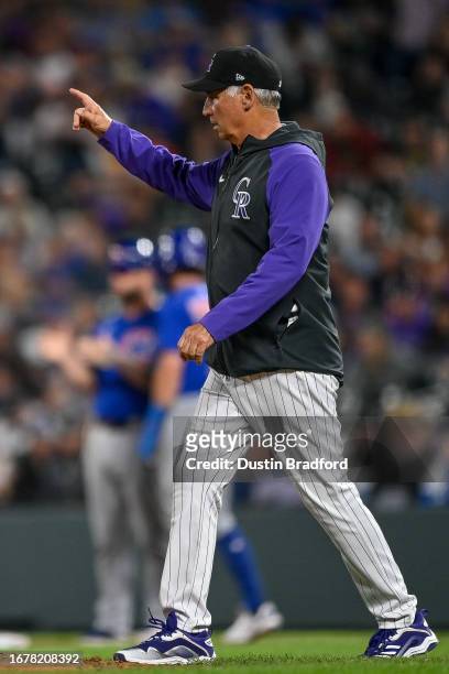 Bud Black of the Colorado Rockies walks to the mound to make a pitching change in the sixth inning against the Chicago Cubs at Coors Field on...